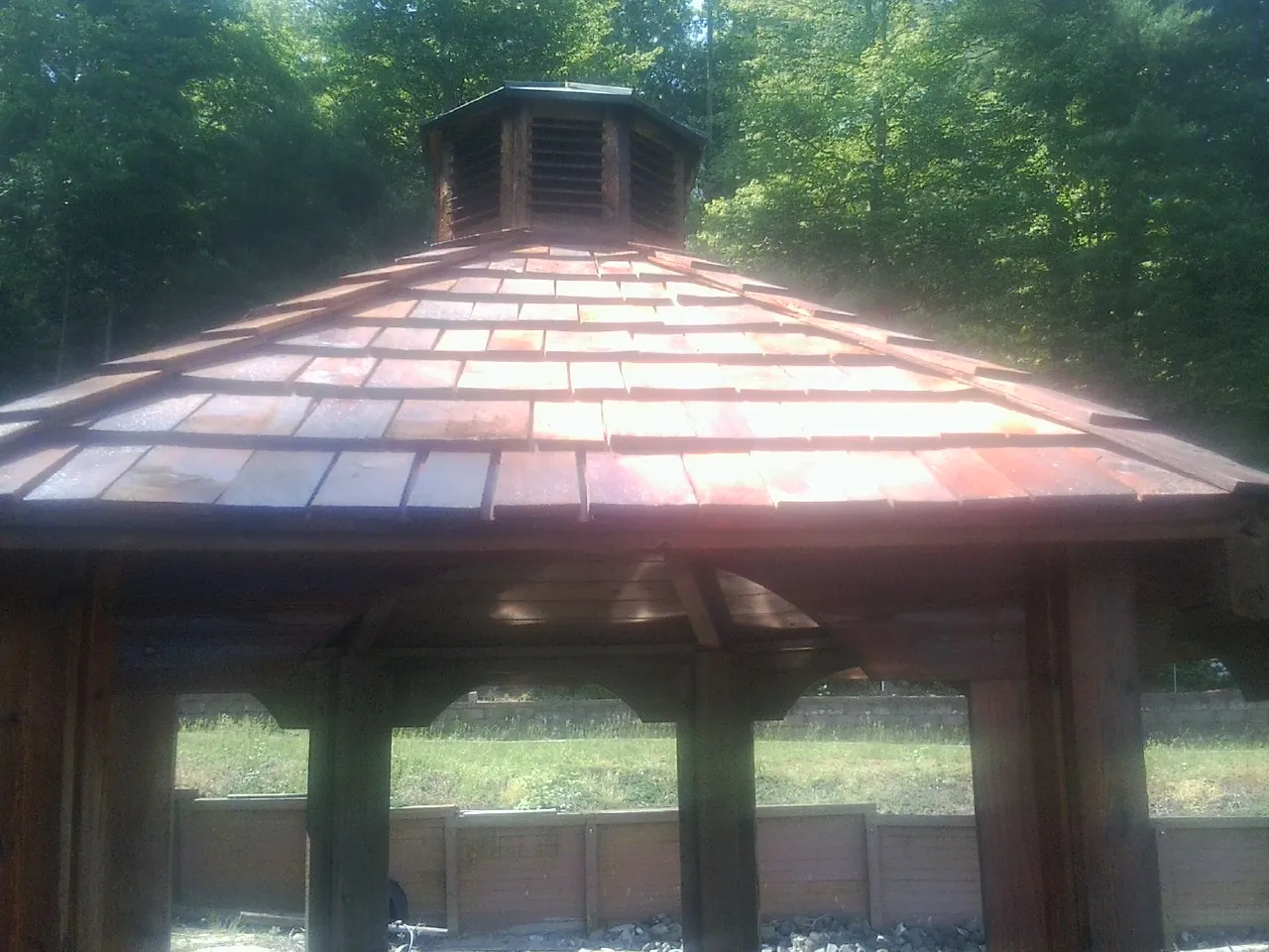 New cedar shake roof and cupola on a lakeside gazebo in Arona
